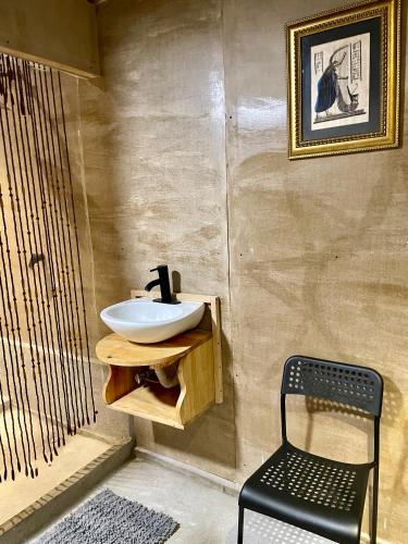 a bathroom with a sink and a chair at EB5 Escape Tzununa, Lake Atitlan Room #3 - two minute walk to the Lake in Tzununá