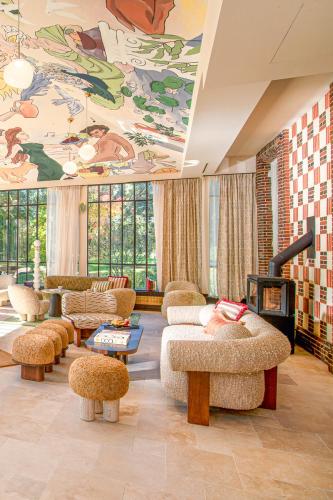 a living room with couches and a painting on the ceiling at Verneuil la douce in Verneuil d'Avre et d'Iton