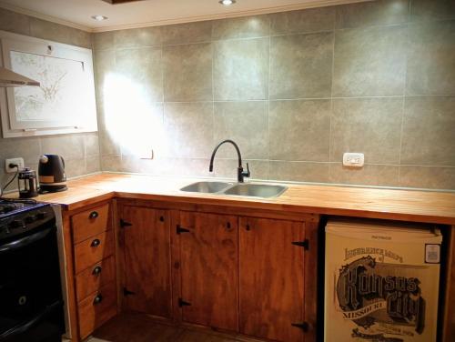 a kitchen with a sink and a stove at Cielo Sur Balsas Loft in Villa La Angostura