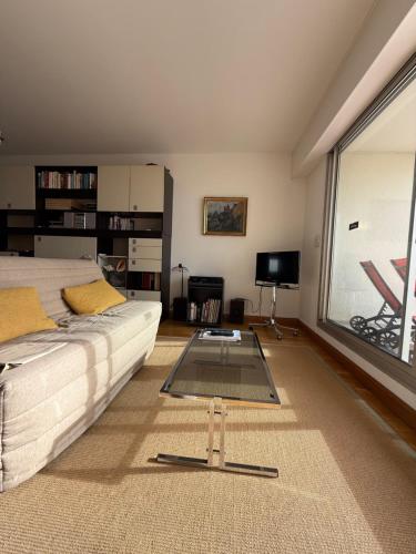 a bedroom with a bed and a large window at Vue Mer Santa Clara 3 in La Baule