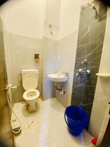 a bathroom with a toilet and a sink at Hotel MAQ Lumbini in Rummindei