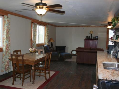 a kitchen and living room with a table and chairs at Secluded Cabin with River and Mountain Views near Columbus, Montana in Nye