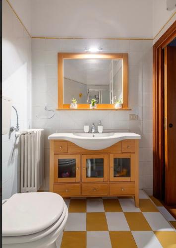 a bathroom with a sink and a toilet and a mirror at Casa Lucale in Palermo