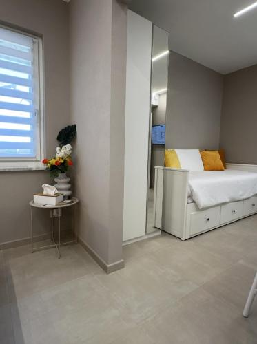 a small bedroom with a bed and a mirror at IsabellaGuestHouse in Chiusa di Pesio