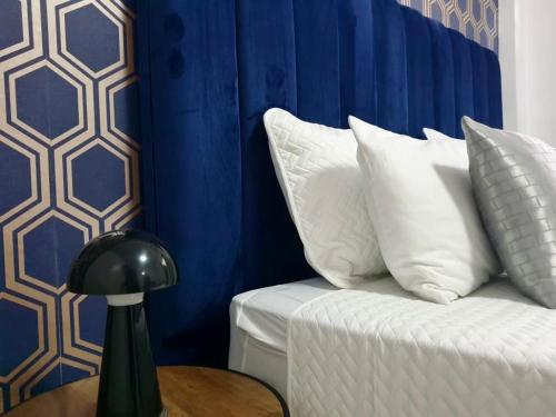 a room with a couch with blue and white pillows at Sages Place in Gaborone