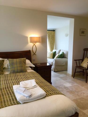 a bedroom with a bed and a living room at Craig-Y-Mor Suites With Sea Views Whitesands Bay St Davids in St. Davids