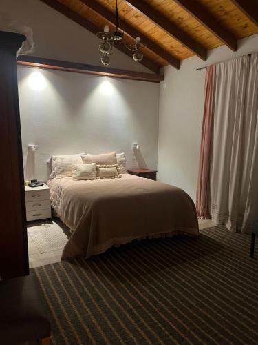 a bedroom with a large bed and a window at Villa Paula in Ranchos