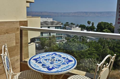 a blue and white table and chairs on a balcony at sea of Galilee 612 in Tiberias