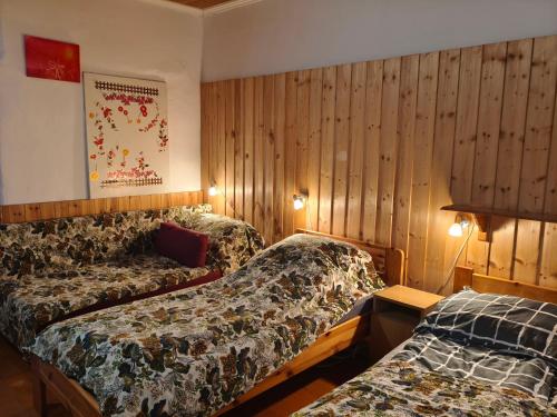 a hotel room with two beds and a couch at Akácvirág Vendégház in Ács