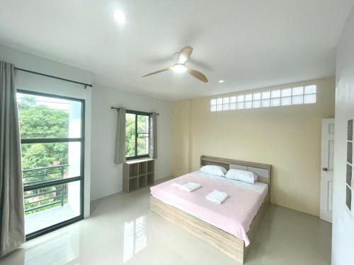 a bedroom with a bed and a ceiling fan at Krabi Rooms - Appartment 4 in Krabi