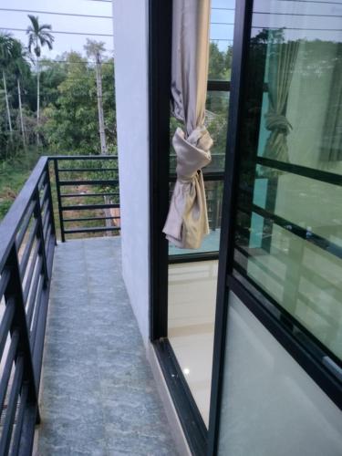 a balcony with a window with a bag on it at Krabi Rooms - Appartment 4 in Krabi
