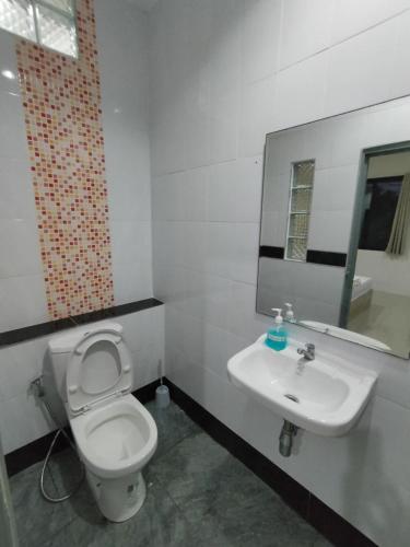 a bathroom with a white toilet and a sink at Krabi Rooms - Appartment 4 in Krabi