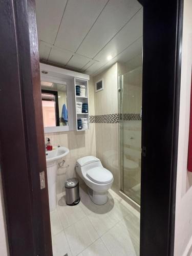 a bathroom with a toilet and a sink and a shower at Apartamento Costa Azul Oasis frente CC La Vela in Porlamar