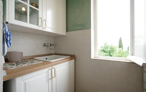 a kitchen with a sink and a window at Galletto del Chianti in Panzano