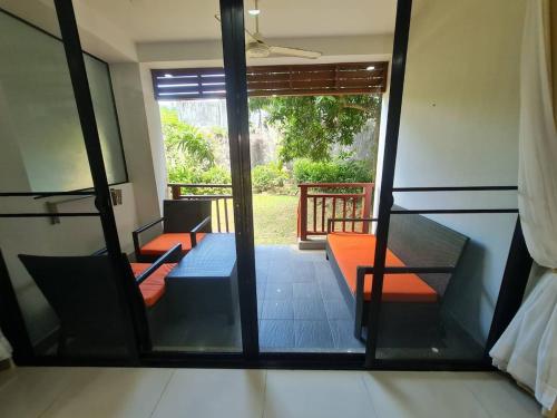 a room with a view of a room with a window at 41 квадратный метр, апартамент на пляже Сурин in Surin Beach