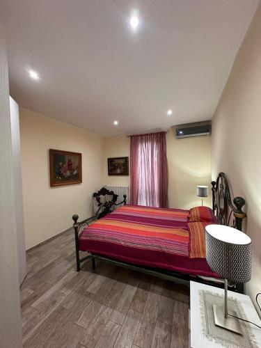 a bedroom with a large bed with a red blanket at SalitaCentrale6 in Bellagio