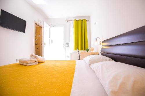 a bedroom with a bed with two towels on it at Donnosanto Residence Torre Santa Sabina in Torre Santa Sabina