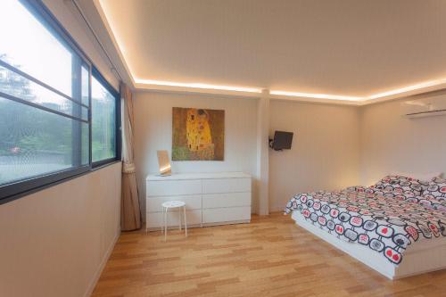 a small bedroom with a bed and a window at Bamboo Garden House in Laem Sing