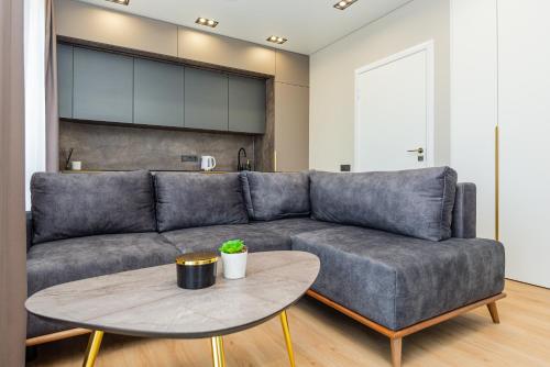 a living room with a couch and a table at Baltic Harmony Apartments in Palanga