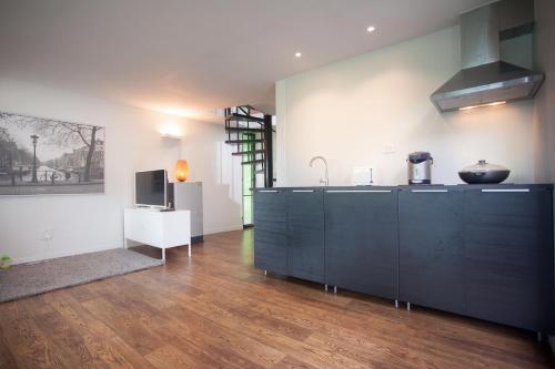 a kitchen with a sink and a counter top at Bamboo Garden House in Laem Sing