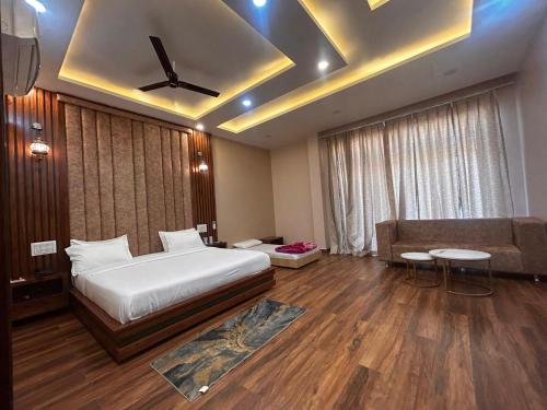 a hotel room with a bed and a couch at The Satluj Vista in Bilāspur
