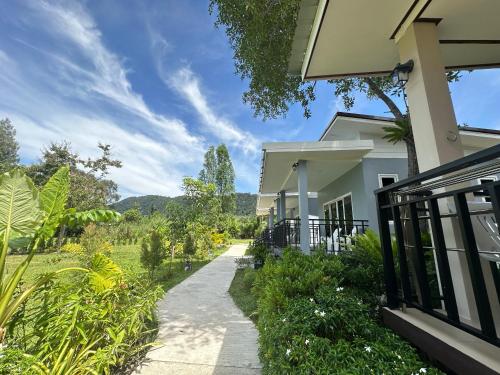a walkway next to a house at Maisuree Lanta Resort-Long Beach in Ko Lanta