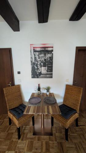 a wooden table and two chairs in a room at Klosterblick in Gengenbach