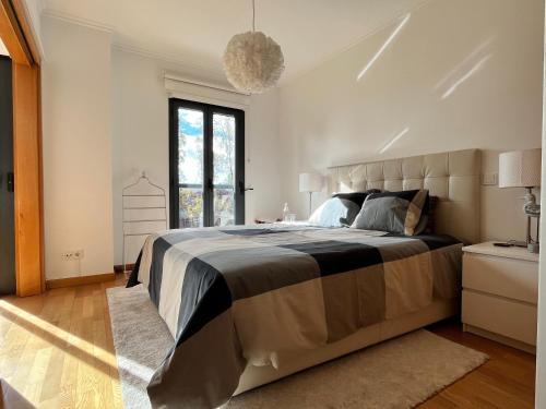 a bedroom with a large bed and a window at Parque Nações - premium location and river view in Lisbon