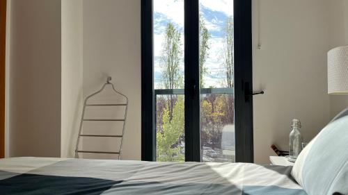 a bedroom with a bed and a window with a ladder at Parque Nações - premium location and river view in Lisbon