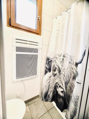 a bathroom with a shower curtain with animals on it at Studio Alsace in Kirchheim