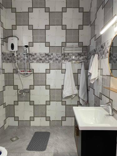 a bathroom with a sink and a shower at maman home apartment in Gisenyi