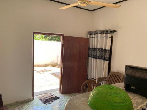 a dining room with a table and a ceiling fan at Hiri Relax Hostal in Dickwella