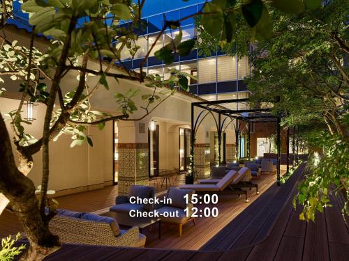 a building with a row of chairs on a deck at Hotel The Celestine Tokyo Shiba in Tokyo