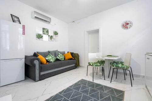 a living room with a couch and a table at Hotel Avner in Bucharest