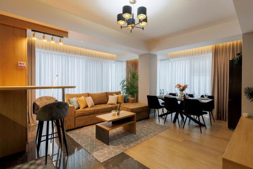 a living room with a couch and a table at Renest New York Skyline View in Chişinău