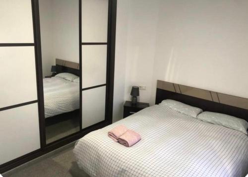 a bedroom with a white bed and a mirror at coparelia 2 in Villarrobledo