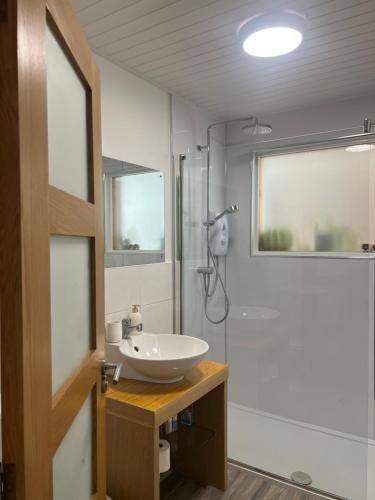 a bathroom with a sink and a shower at Shamerbrea Bed and Breakfast at Cleikum Social Eating in Inverness