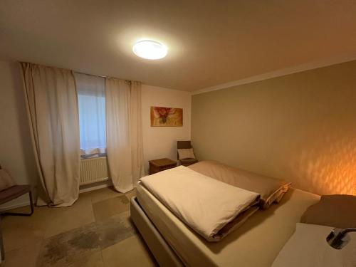 a small bedroom with a bed and a window at Appartement am Rüsberg in Witten