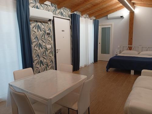 a living room with a table and a bed at Iris Cottage in Anzola dell'Emilia
