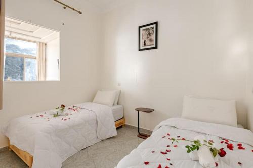a bedroom with two beds and a window at Dar Ourika - Mountain Views in Ourika