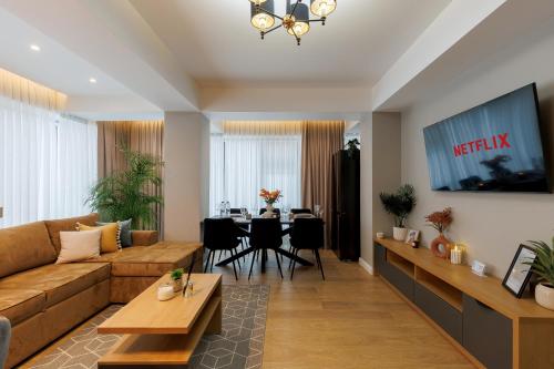 a living room with a couch and a table at Renest New York Skyline View in Chişinău