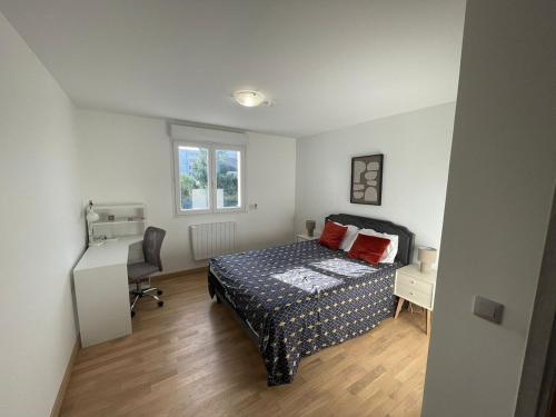 a bedroom with a bed and a desk and a window at Pavillion Peuple de l'Herbe in Carrières-sous-Poissy