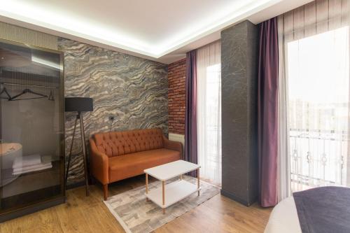 a living room with a couch and a table at Nomad Hub Suit İstanbul in Istanbul
