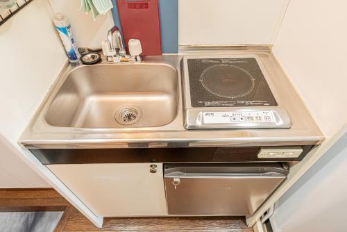 a kitchen with a sink and a stove at sakura 403 in Tokyo