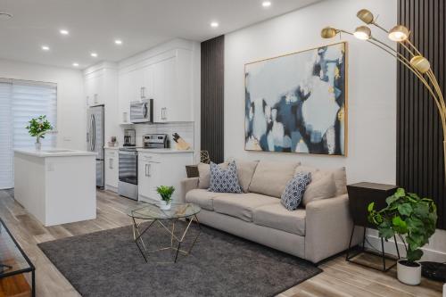 a living room with a couch and a kitchen at Townhome with Free Parking, Near Downtown in Calgary