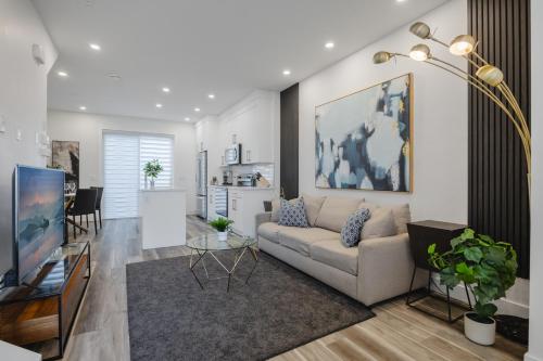 a living room with a couch and a tv at Townhome with Free Parking, Near Downtown in Calgary