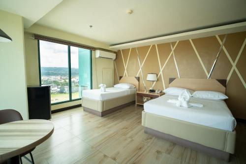 Postel nebo postele na pokoji v ubytování New Dawn Hotel Plus