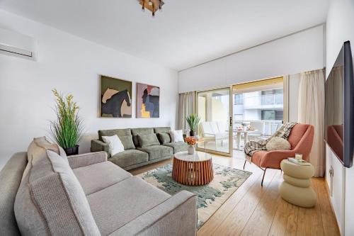 a living room with a couch and a table at Lena Court - Spacious 3bdr, City Views in Limassol
