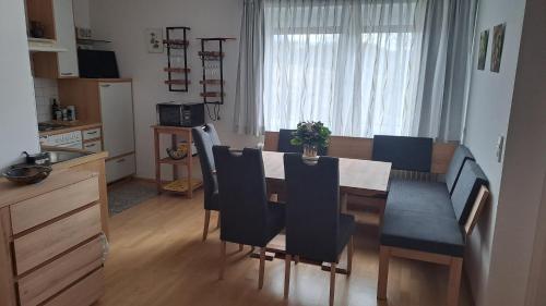 a kitchen and dining room with a table and chairs at Apartments Stissen - Hideaway am Sonnhügel in Faak am See