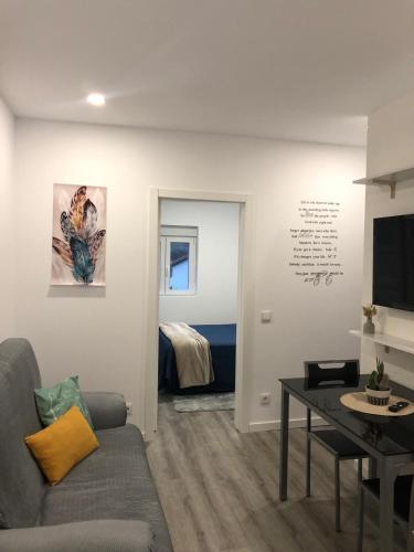 a living room with a couch and a table at Casa das Oliveiras